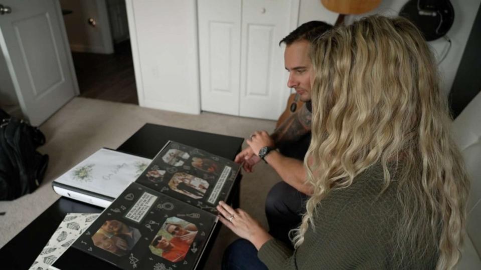 PHOTO: Angela and Chris Winder look through photo albums of their engagement and wedding. (ABC News)