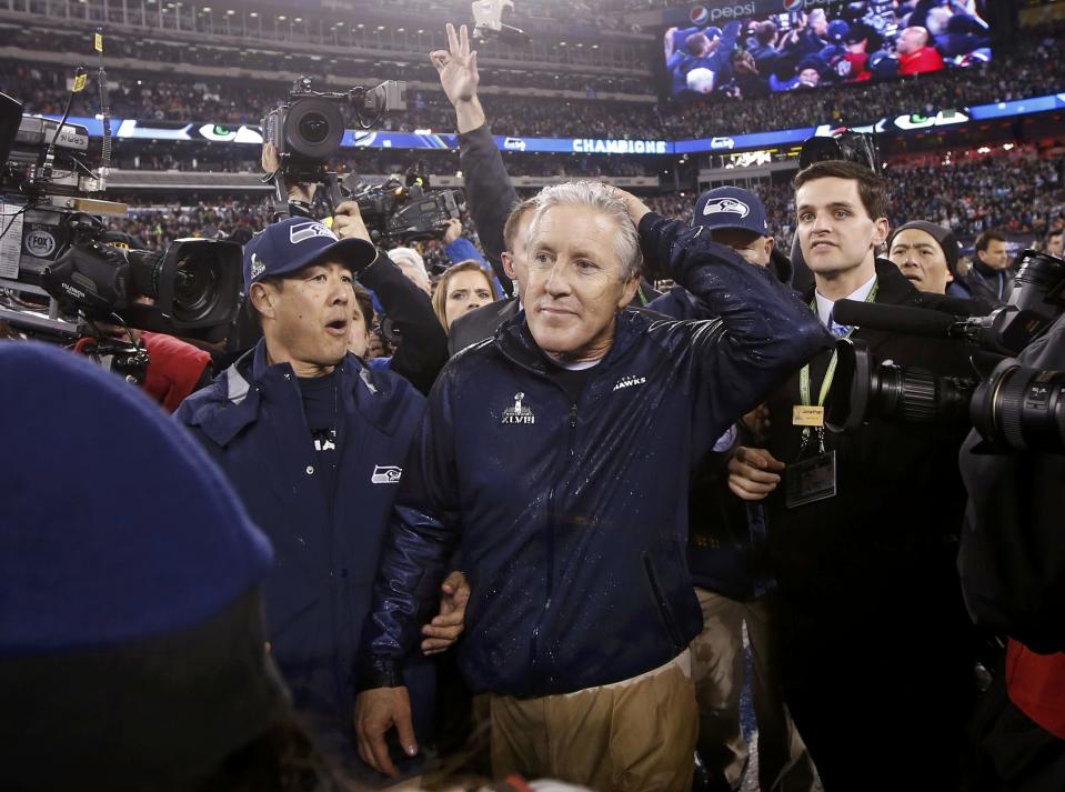 Seattle Seahawks head coach Carroll waits to shake hands with Denver Broncos head coach Fox after Seattle defeated Denver in the NFL Super Bowl XLVIII football game in East Rutherford