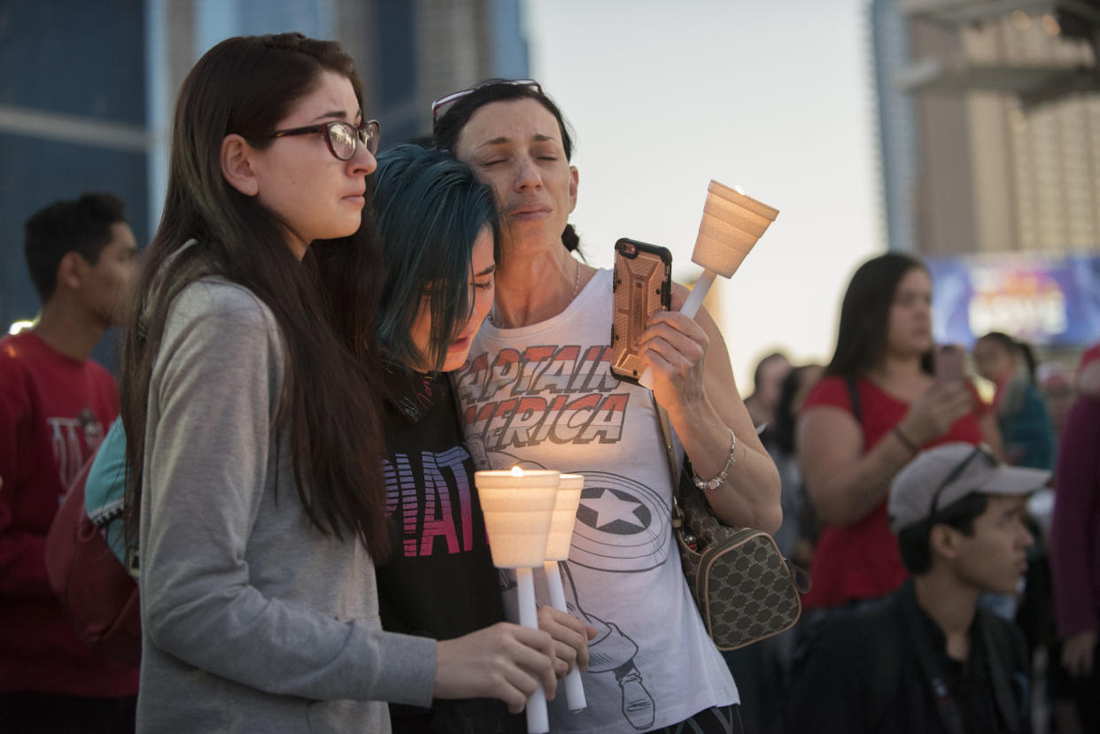 Mourners comfort each other during a candlelight vigil held on the north end of the Las Vegas strip across the street from the SLS hotel and casino on Oct. 2, 2017. (Photo: Martin S. Fuentes for HuffPost)