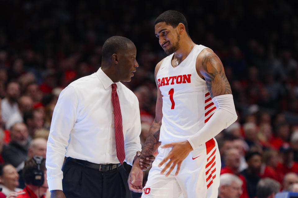 FILE - In this Dec. 14, 2019, file photo, Dayton head coach Anthony Grant, left, speaks with Obi Toppin (1) during the second half of an NCAA college basketball game against Drake, in Dayton, Ohio. Toppin and Grant have claimed top honors from The Associated Press after leading the Flyers to a No. 3 final ranking. Toppin was voted the AP men's college basketball player of the year. Grant is the AP coach of the year. (AP Photo/John Minchillo, File)