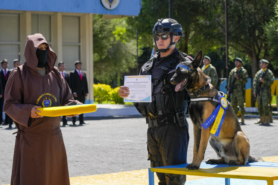 Apolo the dog receives a medal during a ceremony that recognizes the work of dogs that belong to the Counterintelligence Group of the Army in Quito, Ecuador, Monday, June 3, 2024. (AP Photo/Dolores Ochoa)