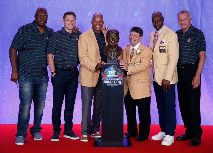 Edward DeBartolo, Jr. (3rd R), former San Francisco 49ers Owner, is seen with his bronze bust alongside former San Francisco 49ers, Charles Haley (L), Steve Young (2nd L), Ronnie Lott (3rd L), Jerry Rice (2nd R) and Joe Montana (R) during the NFL Hall of Fame Enshrinement Ceremony. (Getty Images)