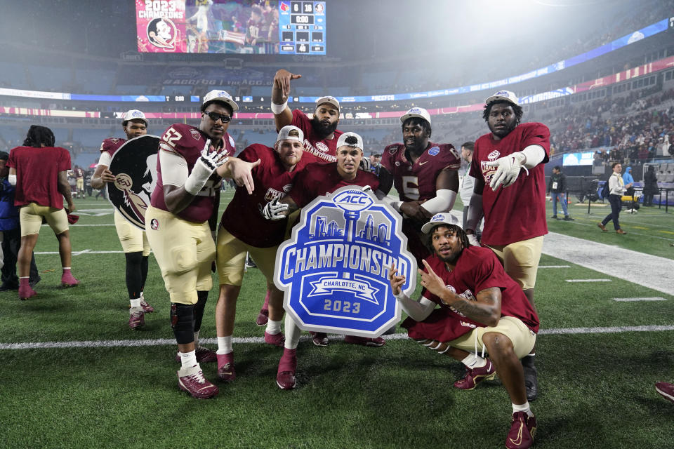 Florida State players pose after defeating Louisville in the Atlantic Coast Conference championship NCAA college football game Saturday, Dec. 2, 2023, in Charlotte, N.C. (AP Photo/Erik Verduzco)