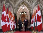 Canada's Prime Minister Stephen Harper (R) walks in the Hall of Honour with India's Prime Minister Narendra Modi on Parliament Hill in Ottawa April 15, 2015. REUTERS/Chris Wattie