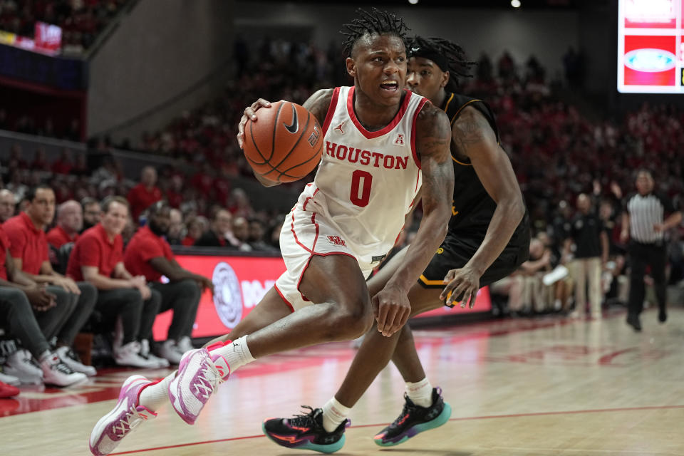 FILE - Houston guard Marcus Sasser (0) drives around Wichita State guard Jaron Pierre Jr. during the second half of an NCAA college basketball game Thursday, March 2, 2023, in Houston. Sasser was selected to the Associated Press All-America first team in results released Tuesday, March 14, 2023. (AP Photo/Kevin M. Cox, File)