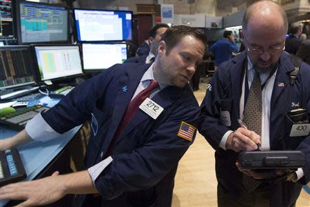 Traders work on the floor of the New York Stock Exchange February 19, 2014. REUTERS/Brendan McDermid