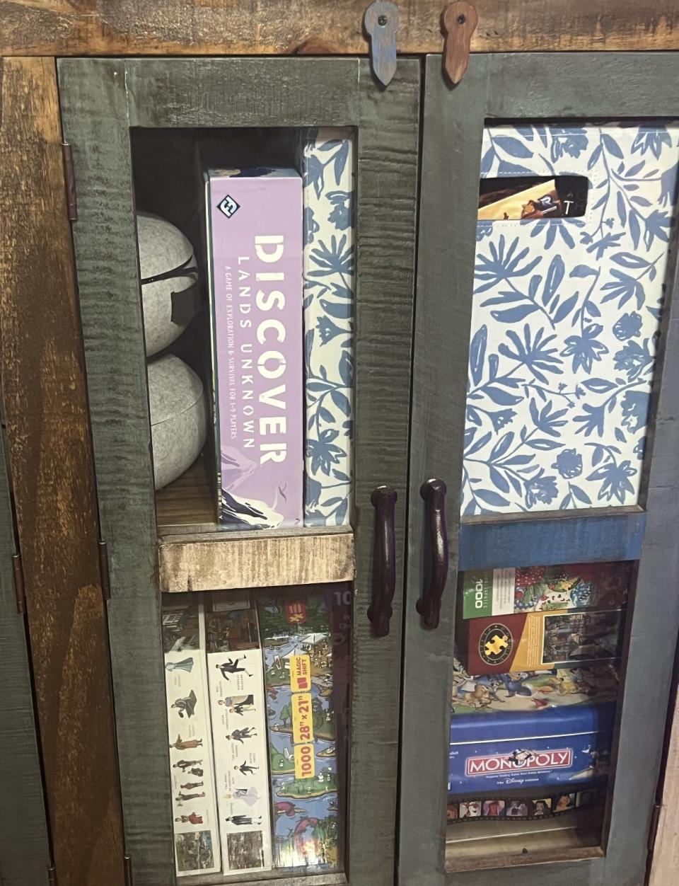 the fabric bin in a board game cabinet.