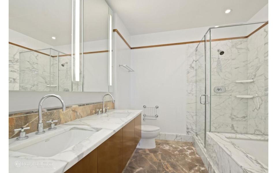 <p>Double sinks, a soaking tub, and a walk-in shower are luxury features of the spacious bathroom.</p>