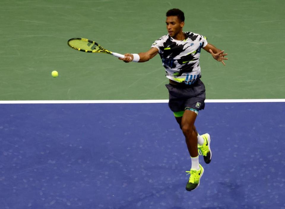 Félix Auger-Aliassime hits a return in his straight-sets defeat of Andy Murray.