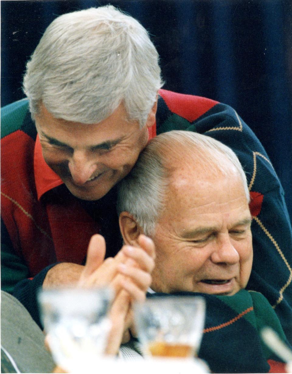 Bob Knight hugs a coaching buddy, Michigan State's Jud Heathcote during the 1994 Big Ten coaches pre-season meeting.