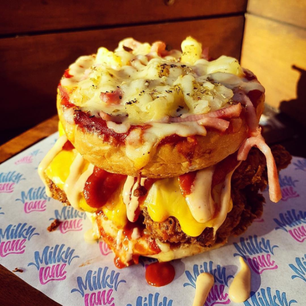 The Hawaiian Pizza Burger is for anyone you believes pineapple DOES belong on pizza. Source: Milky Lane