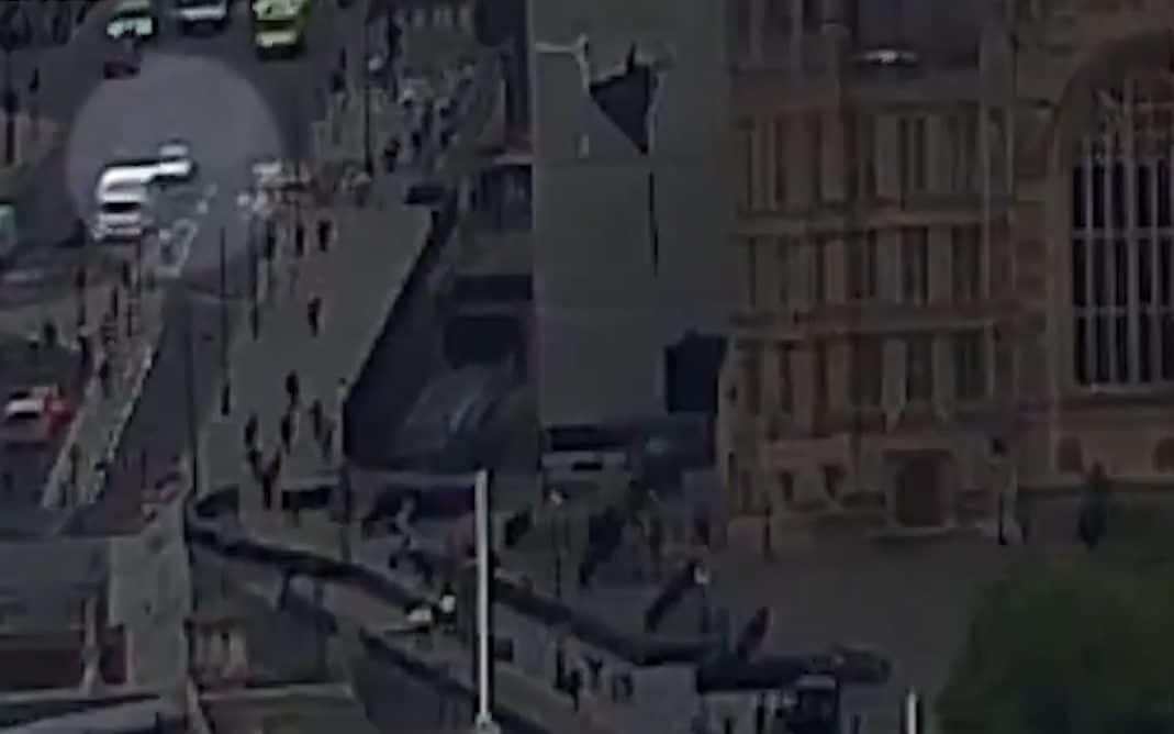 The car, circled, drives past Westminster Abbey