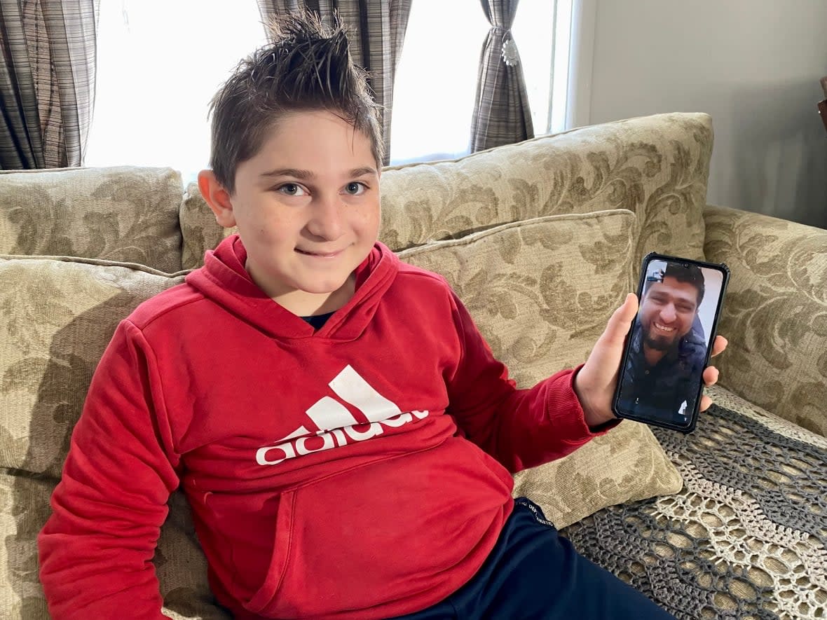 From his Saskatoon home, Adnan Kharsa spoke to his father in Turkey over video chat in April 2022. The Syrian refugee hasn't seen his parents in person since 2017. (Bonnie Allen/CBC - image credit)