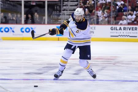 Nov 2, 2017; Glendale, AZ, USA; Buffalo Sabres defenseman Marco Scandella (6) shoots the puck during the third period against the Arizona Coyotes at Gila River Arena. Matt Kartozian-USA TODAY Sports