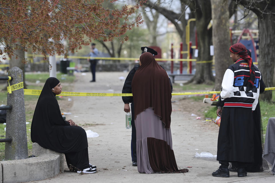 People speak to police following a shooting at an Eid al-Fitr event, Wednesday, April 10, 2024, in Philadelphia. (Monica Herndon/The Philadelphia Inquirer via AP)