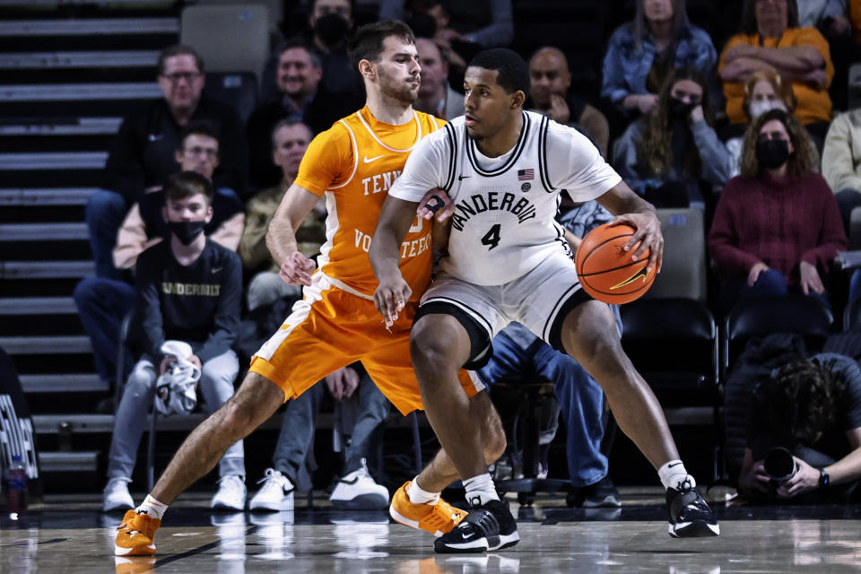 Vanderbilt forward Jordan Wright (4) works for a shot against Tennessee guard Santiago Vescovi (25) during an NCAA college basketball game Tuesday, Jan. 18, 2022, in Nashville, Tenn. (AP Photo/Wade Payne)