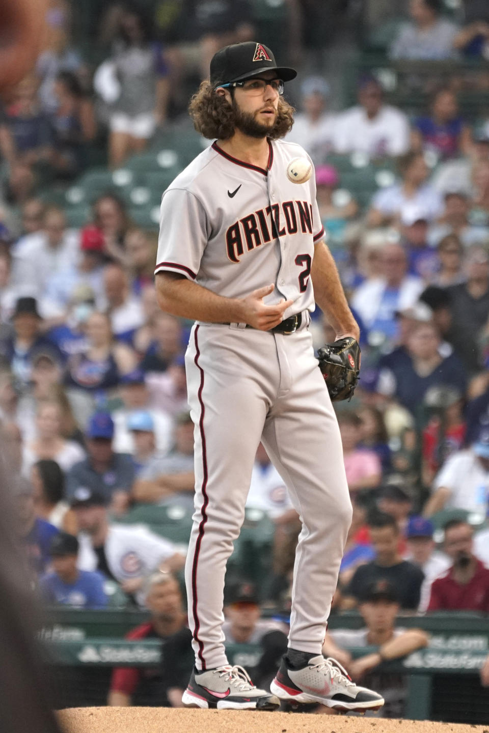 Arizona Diamondbacks starting pitcher Zac Gallen tosses the ball during the first inning of a baseball game against the Chicago Cubs in Chicago, Friday, July 23, 2021. (AP Photo/Nam Y. Huh)