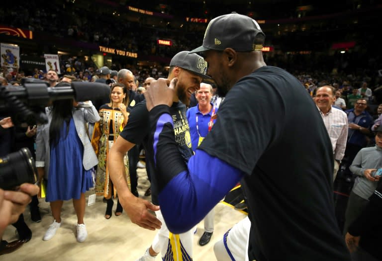 Kevin Durant and Stephen Curry of the Golden State Warriors celebrate after defeating the Cleveland Cavaliers in game four to sweep the 2018 NBA Finals