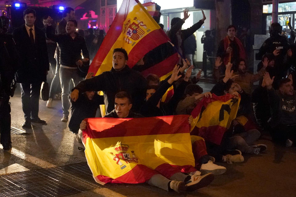 Demonstrators block the street during a protest against the amnesty at the headquarters of Socialist party in Madrid, Spain, Thursday, Nov. 16, 2023. Spain's acting Socialist prime minister, Pedro Sánchez, has been chosen by a majority of legislators to form a new leftist coalition government in a parliamentary vote. The vote came after nearly two days of debate among party leaders that centered almost entirely on a highly controversial amnesty deal for Catalonia's separatists that Sánchez agreed to in return for vital support to get elected prime minister again. (AP Photo/Andrea Comas)