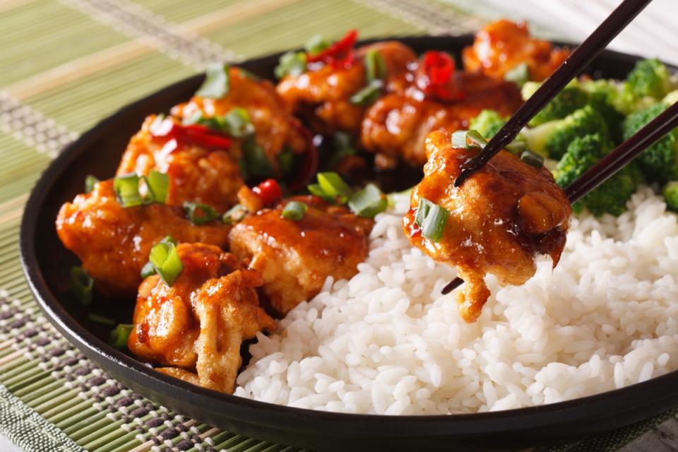 Asian food: General Tso's chicken with rice for dinner. Horizontal close-up