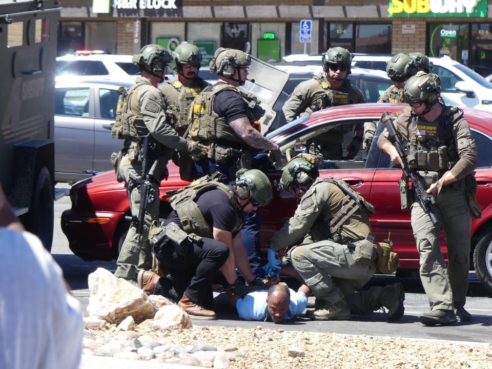 A SWAT team engaged in a standoff with a man refusing to exit a car in the parking lot of an Apple Valley Stater Bros. store near Navajo Road before ultimately being taken into custody on Wednesday afternoon.