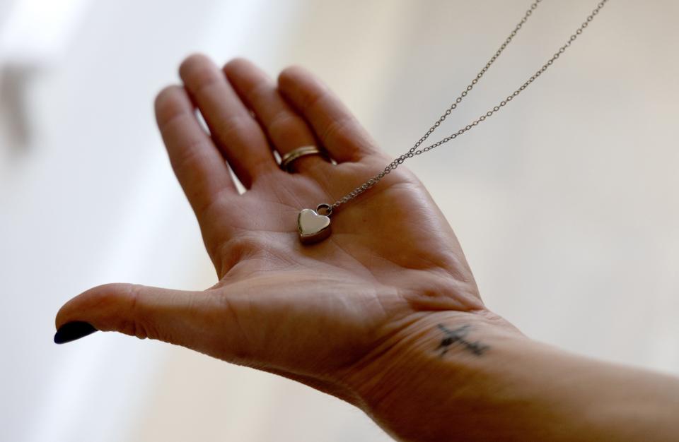 Amanda Zurawski holds the remains of her daughter, Willow, in a heart-shaped locket on June 11, 2023, in her home in Austin, Texas.