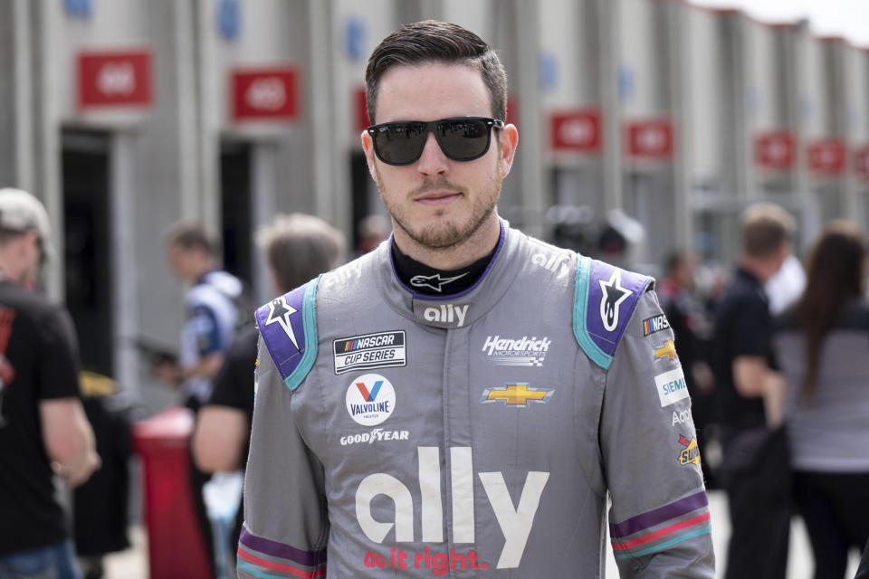 Alex Bowman walks from his garage before qualifying in seventh position for the NASCAR Cup Series auto race at Charlotte Motor Speedway on Saturday, May 29, 2021 in Charlotte, N.C. (AP Photo/Ben Gray)