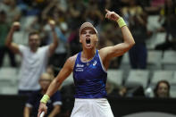 Laura Pigossi, of Brazil, celebrates a point against Tatjana Maria, of Germany, during their Billie Jean King Cup tennis match, in Sao Paulo, Brazil, Friday, April 12, 2024. (AP Photo/Andre Penner)