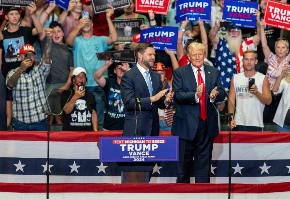 Vice-presidential nominee JD Vance, left, stands next to former President Donald Trump during a rally at the Van Andel Arena in Grand Rapids, Mich., on Saturday, July 20, 2024.