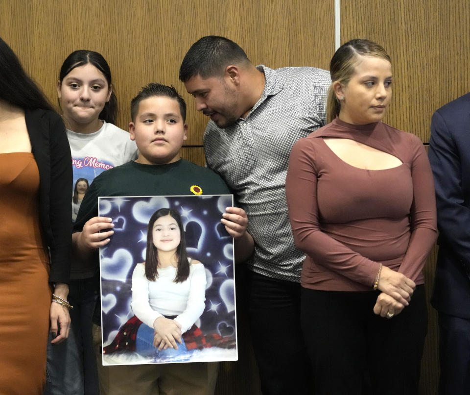 Arlene Alvarez's dad, Armando Alvarez, whispers to his son, Armando Alvarez Jr., 9, with wife Wendy during a press conference to discuss the indictment of Tony Earls in the death of the 9-year-old in 2022 at Crime Stoppers on Wednesday, April 24, 2024, in Houston. (Karen Warren/Houston Chronicle via AP)