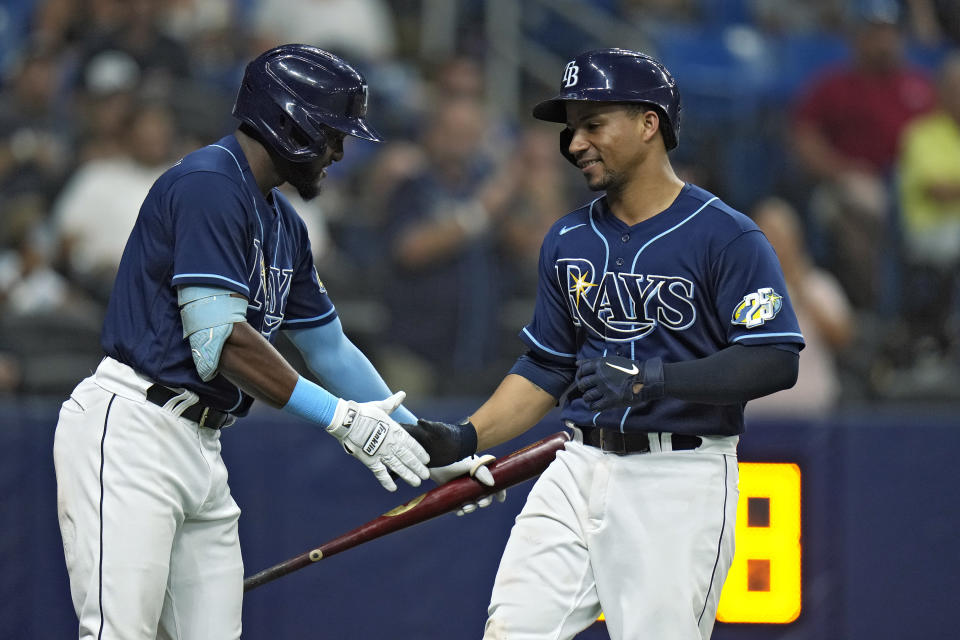 Tampa Bay Rays' Francisco Mejia, right, shakes hands with on-deck batter Vidal Brujan after Mejia hit a solo home run off Kansas City Royals relief pitcher Taylor Clarke during the seventh inning of a baseball game Thursday, June 22, 2023, in St. Petersburg, Fla. (AP Photo/Chris O'Meara)