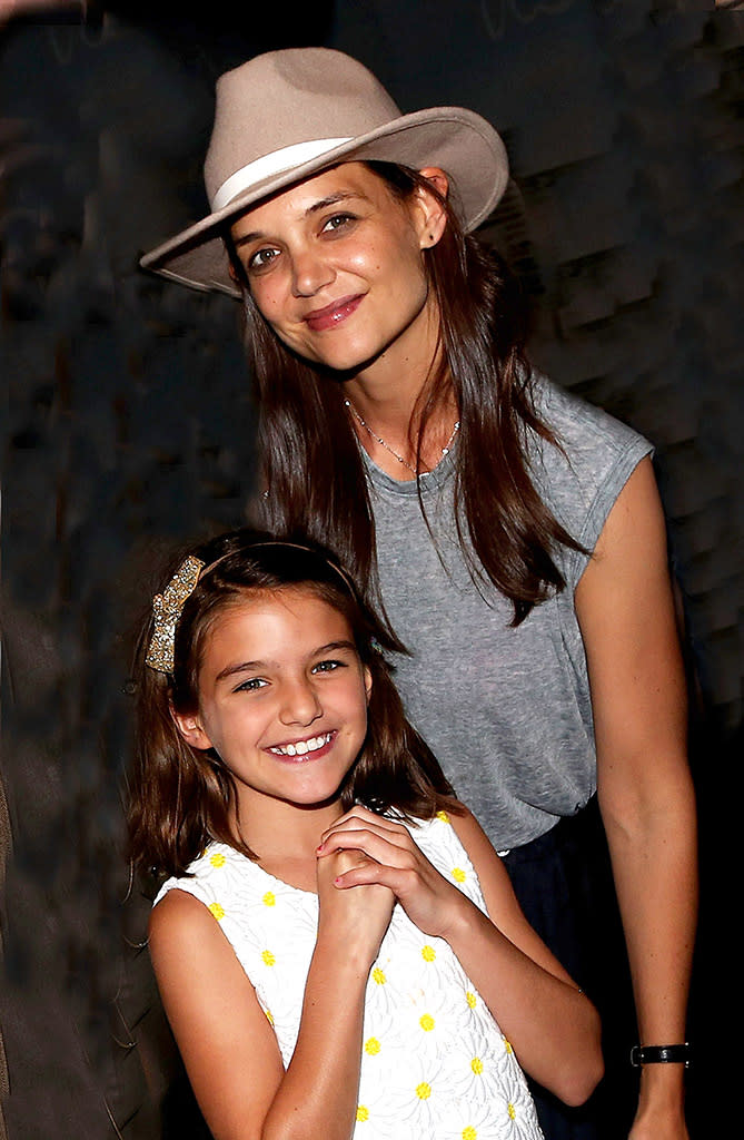 Suri Cruise and Katie Holmes pose at Finding Neverland