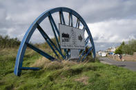 A closed sign outside the Haig Colliery Mining Museum close to the site of a proposed new coal mine near the Cumbrian town of Whitehaven in northwest England, Monday, Oct. 4, 2021. (AP Photo/Jon Super)