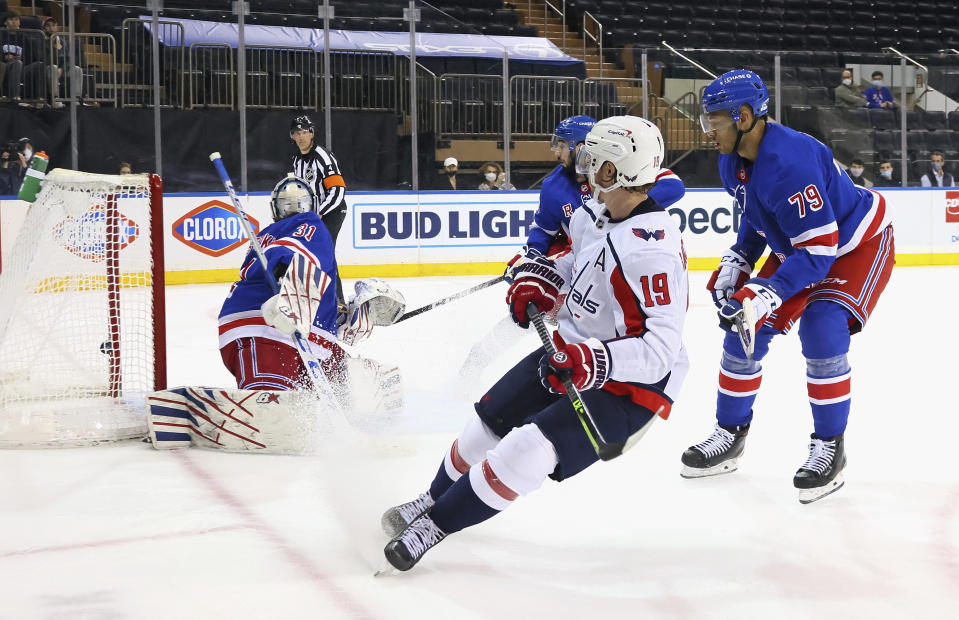 Nicklas Backstrom, center, of the Washington Capitals scores in the third period against Igor Shesterkin, left, of the New York Rangers during an NHL hockey game Monday, May 3, 2021, in New York. (Bruce Bennett/Pool Photo via AP)