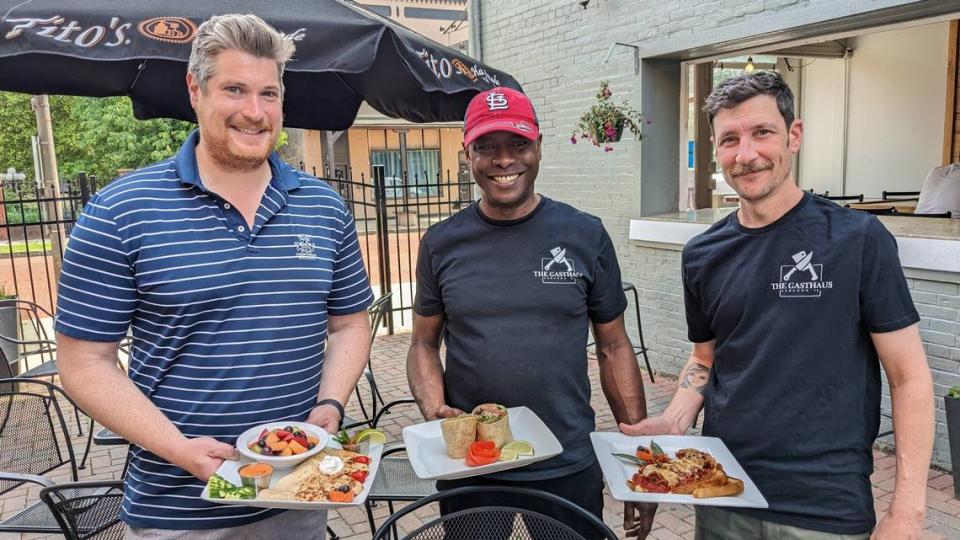 The Gasthaus owners Mac Rohr, Maurice Nelson and Cameron Volk show off some of the entrées created by Nelson, who is also the restaurant’s new executive chef.