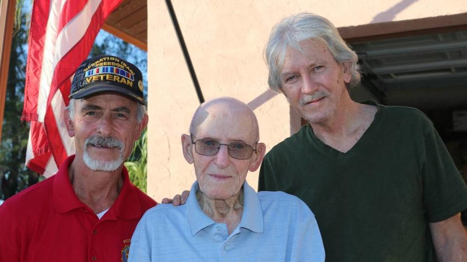  John V. Skeen, a 105-year-old Bradenton resident and World War II combat veteran, has been selected grand marshal for the 2023 Manatee County Veterans Day parade. At left is his friend, retired Lt. Col. Kevin W. Wright. At right is his son Greg Skeen.