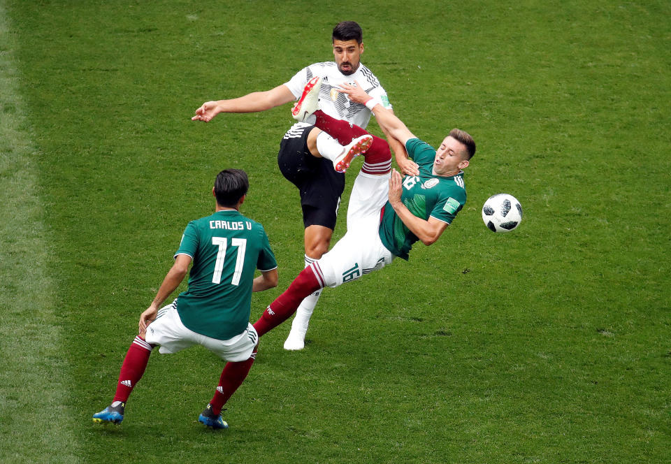 Germany's Sami Khedira in action with Mexico's Carlos Vela and Hector Herrera.