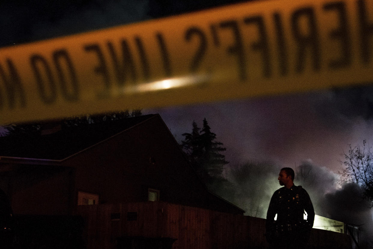 Emergency personnel is shown at the scene of a fire and explosion at a home in Flint, Mich., Monday night, Nov. 22, 2021. Three people were missing following the fire and explosion, authorities said. (Isaac RitcheyThe Flint Journal via AP)