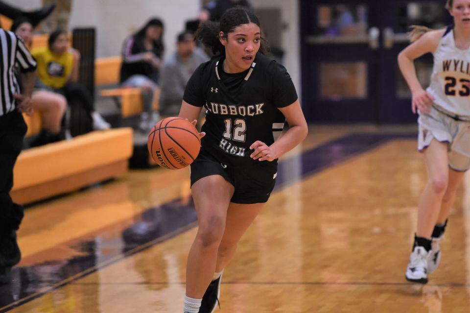 Lubbock High's Faith Ford (12) looks up as she brings the ball down the court during Tuesday's game against Wylie. Ford scored a team-high 14 points in the 50-38 loss.