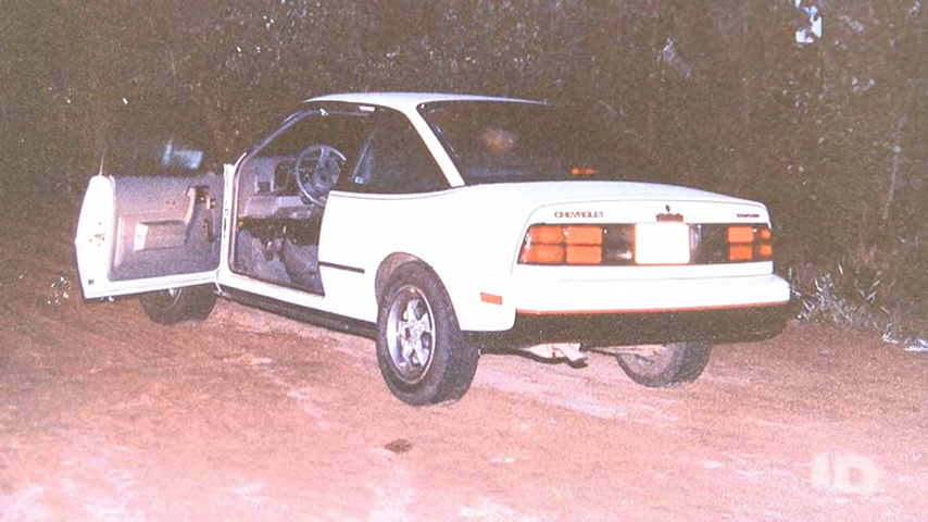 old photo of a car with the driver's door opened