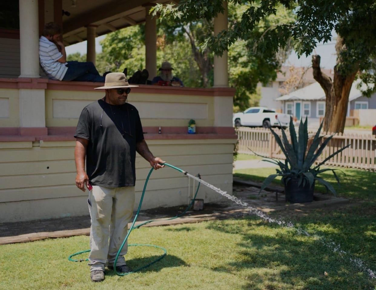 Jeff Peters waters the grass at Lighthouse Rescue Mission. Lighthouse Rescue Mission was awarded $500,000 from Tulare City Council. The money will go toward maintenance, operations and payroll.