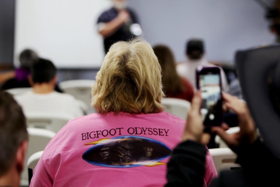 Darla Logan, of Poplar Bluff, wears a "Bigfoot Odyssey" shirt while listening to a speaker during the Ozark Mountain Bigfoot Conference Oct. 8, 2022.