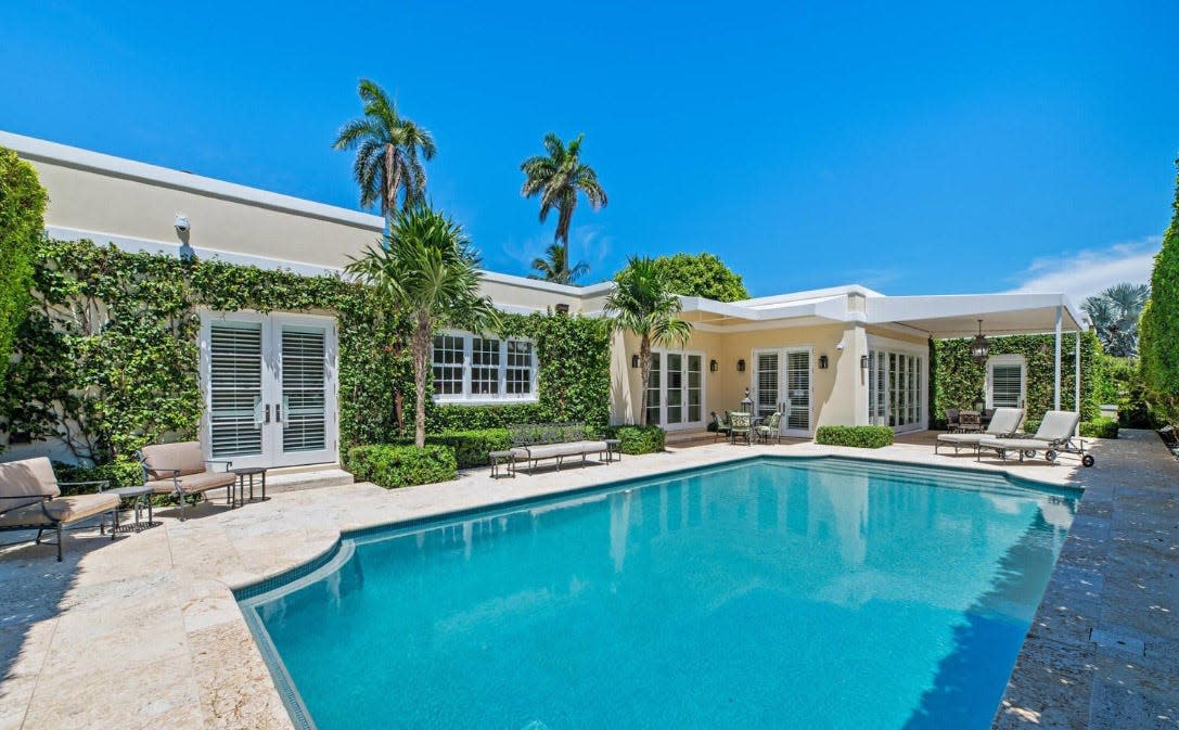 French doors open to the pool area at a Palm Beach house at 302 Via Linda, which is listed for sale at $16.85 million.