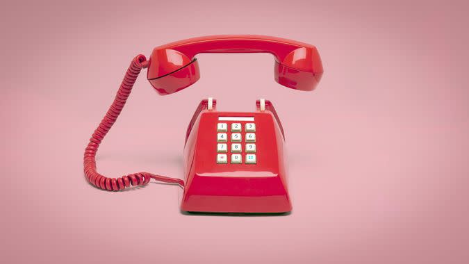 Retro pink telephone on pink background, Vintage style colors.