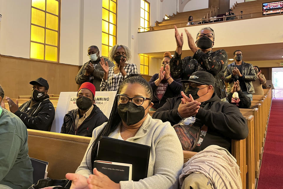People applaud chair Kamilah Moore during a reparations task force meeting at Third Baptist Church in San Francisco, Wednesday, April 13, 2022. California's first-in-the-nation reparations task force met for the first time since its inaugural meeting nearly a year ago. The live meeting also comes mere weeks after the group voted to limit restitution to descendants of enslaved or free Black people in the U.S. before the 20th century. (AP Photo/Janie Har)