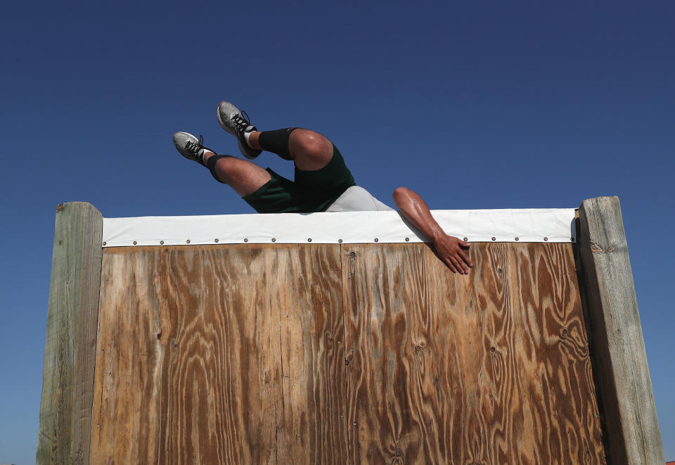 <p>A U.S. Border Patrol trainee climbs over an obstacle course wall at the U.S. Border Patrol Academy on August 3, 2017 in Artesia, N.M. (Photo: John Moore/Getty Images) </p>