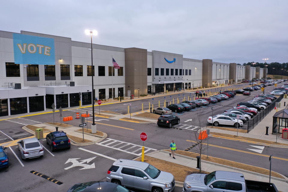 A banner with &#x00201c;VOTE&#x00201d; on it is displayed facing the employee parking lot at an Amazon facility on the first day of the unionizing vote, in Bessemer, Alabama, U.S., February 4, 2022. Picture taken with a drone. REUTERS/Dustin Chambers