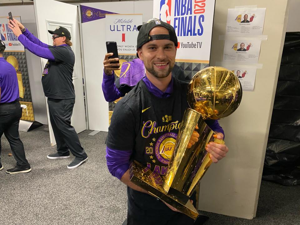 Equipment manager Andrew Henk holds the Larry O'Brien Trophy outside the Los Angeles Lakers' locker room in Orlando. The 29-year-old from Shelby Township was a team manager for Michigan State basketball and an assistant equipment manager with the PIstons before taking over his new job this season.