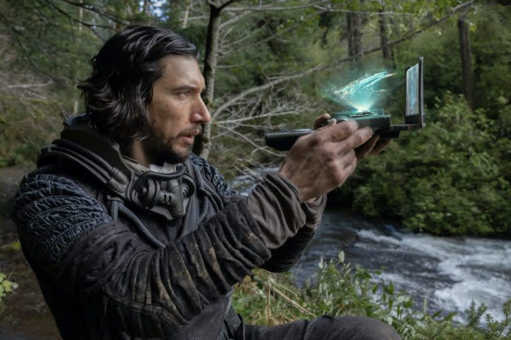 Adam Driver holds a futuristic scanner in 65.