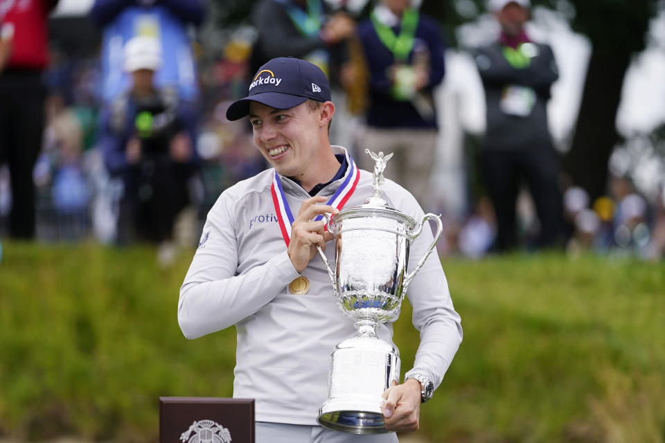 Matthew Fitzpatrick, of England, celebrates with the trophy after winning the U.S. Open golf tournament at The Country Club, Sunday, June 19, 2022, in Brookline, Mass. (AP Photo/Julio Cortez)